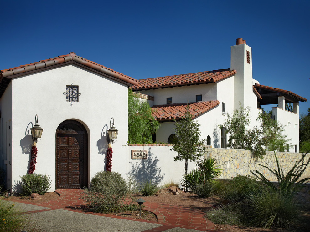 Example of a tuscan two-story exterior home design in Austin with a tile roof