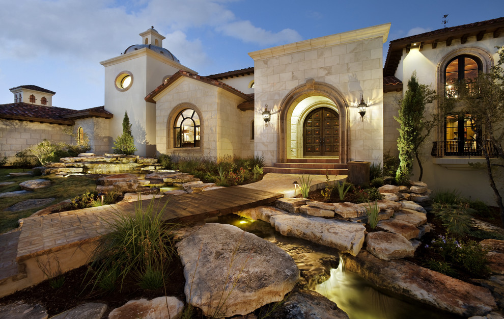 Example of a tuscan one-story exterior home design in Austin