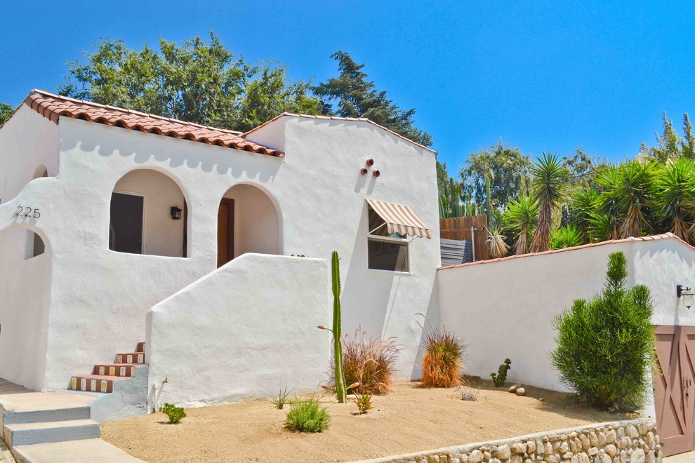 Southwest white one-story exterior home photo in Los Angeles with a tile roof