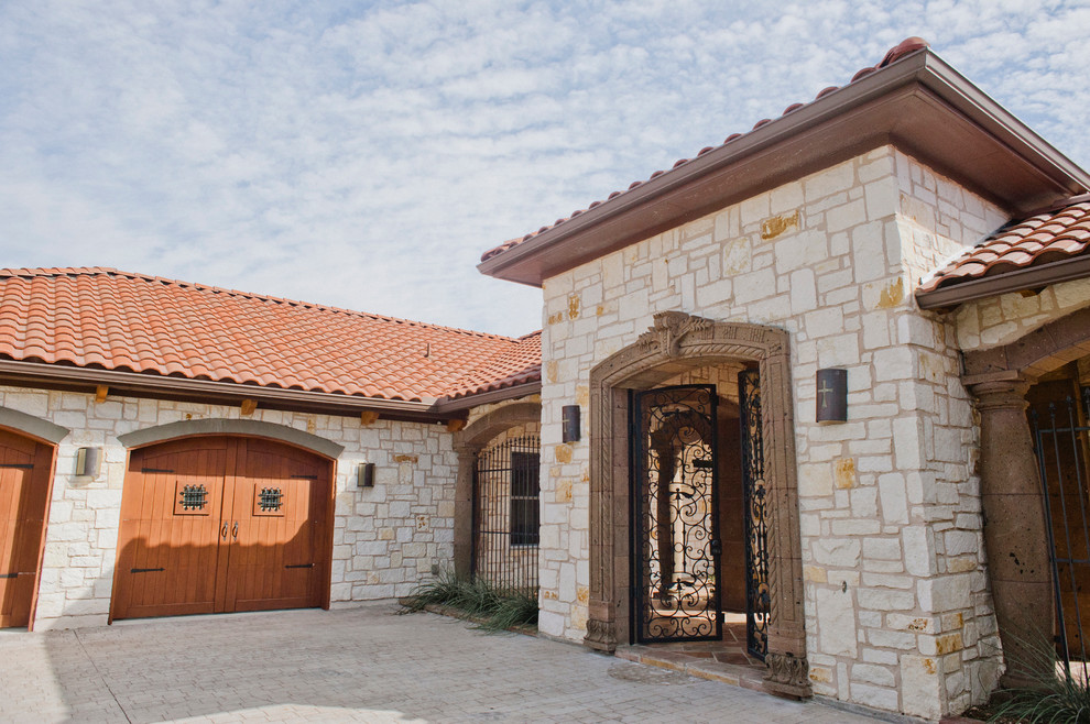 Inspiration for an expansive and white rustic two floor house exterior in Austin with stone cladding.