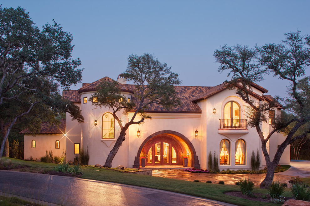 Photo of a mediterranean two floor house exterior in Austin.