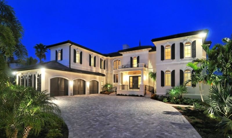 Example of a large tuscan white two-story stucco exterior home design in Tampa with a hip roof