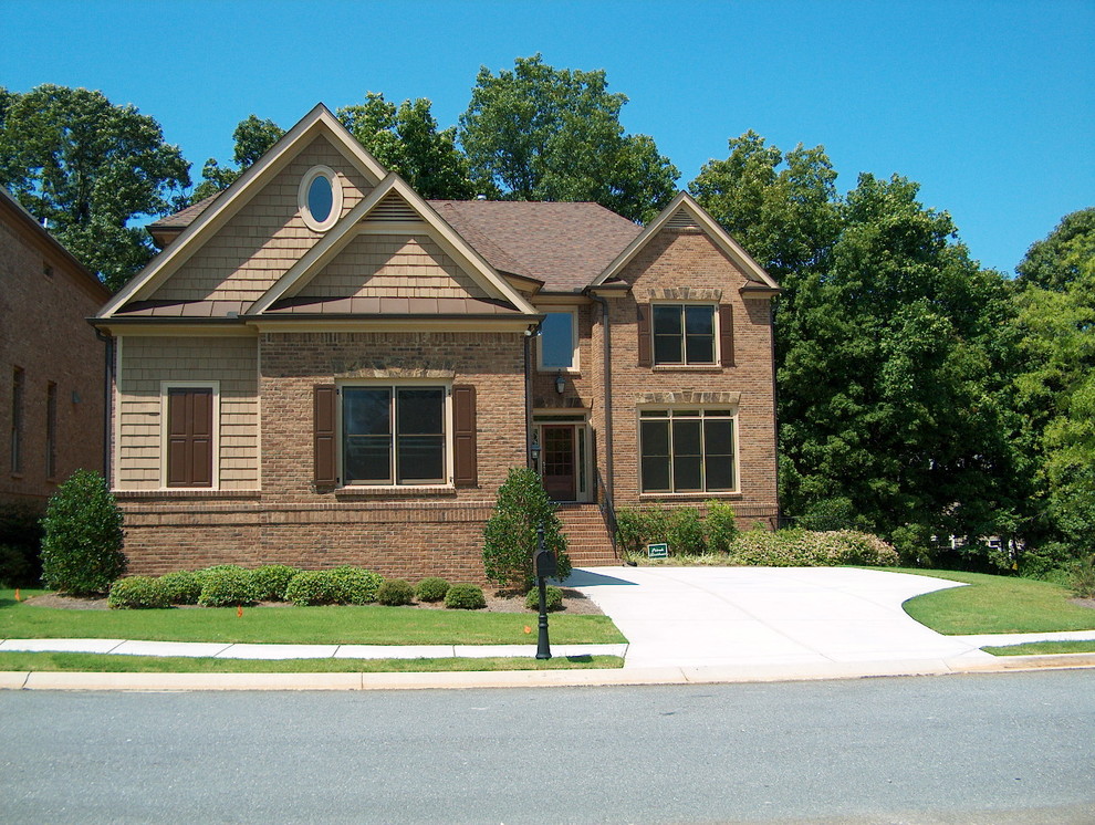 Example of a large classic brown two-story brick exterior home design in Atlanta