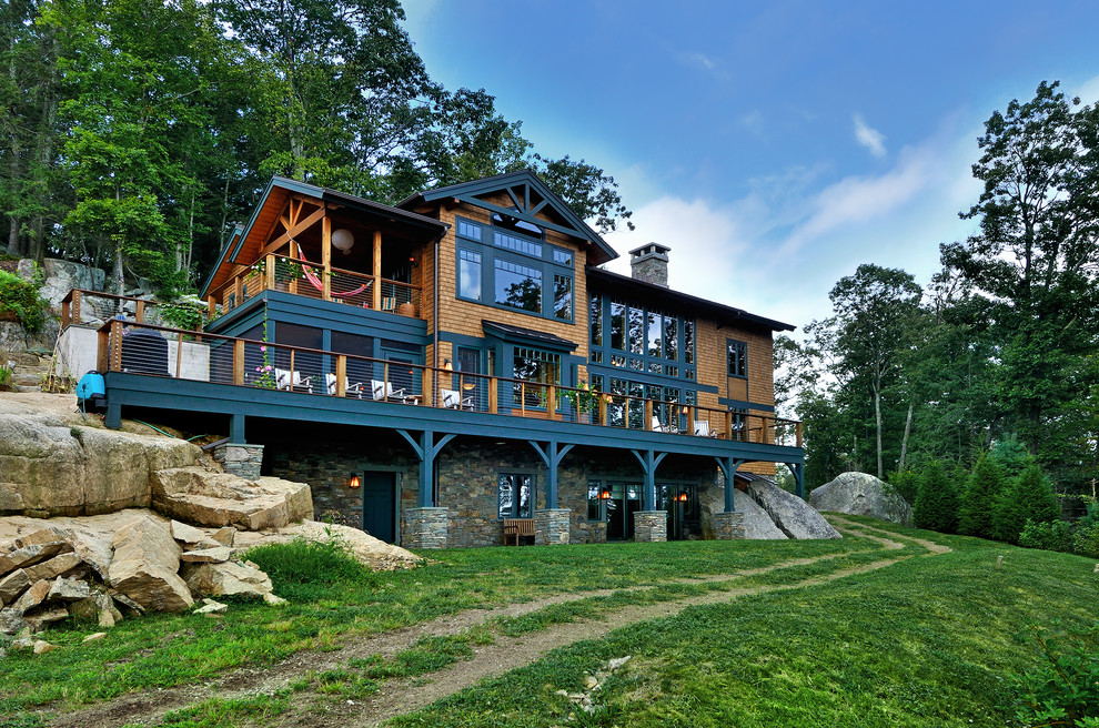 Inspiration for a large rustic three-story wood exterior home remodel in New York