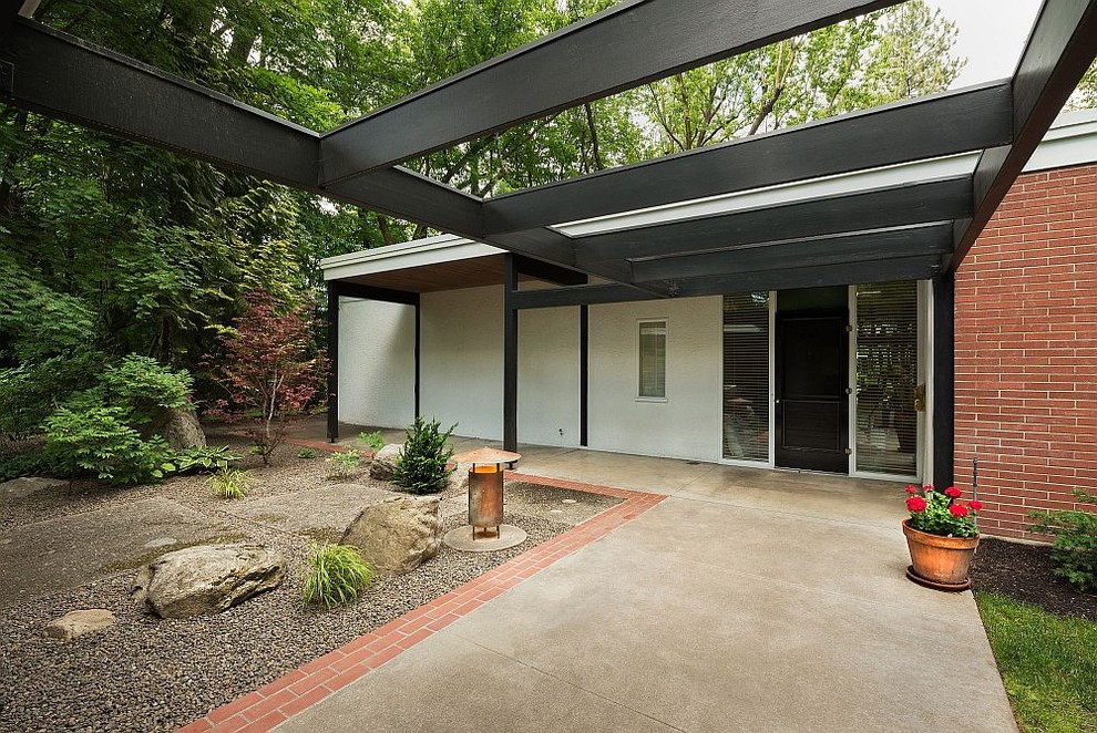 Example of a mid-century modern exterior home design in Other