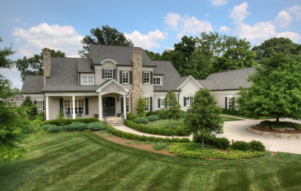 Large traditional gray two-story stucco exterior home idea in Louisville
