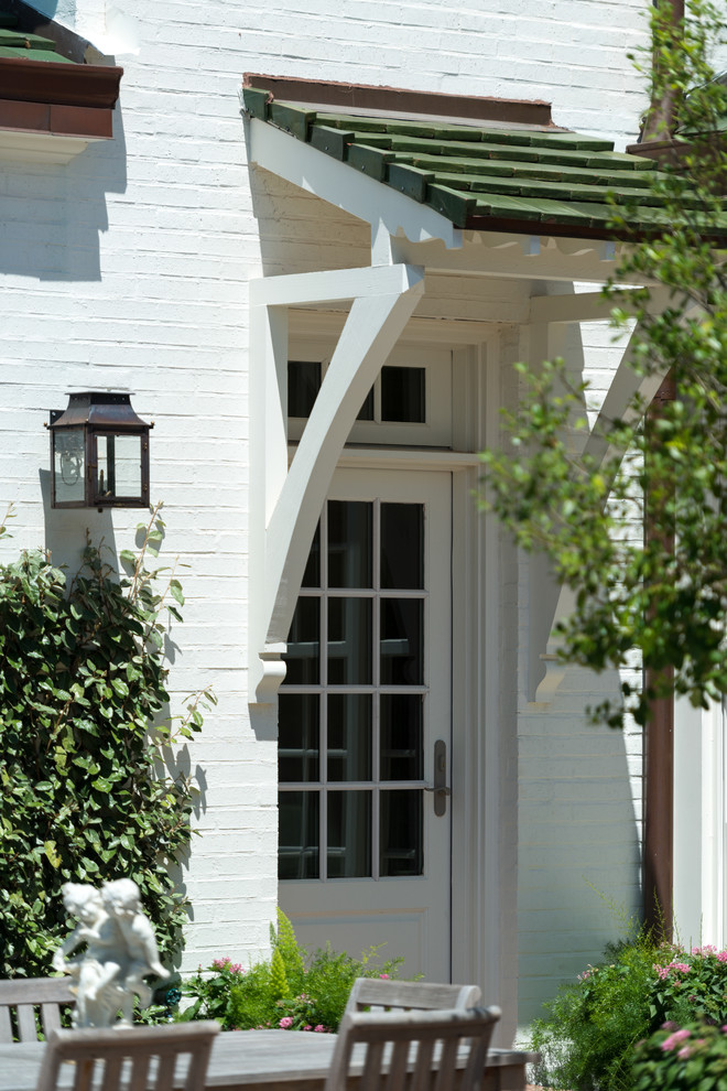 Modelo de fachada de casa blanca clásica de tamaño medio de dos plantas con revestimiento de ladrillo, tejado a dos aguas y tejado de teja de madera
