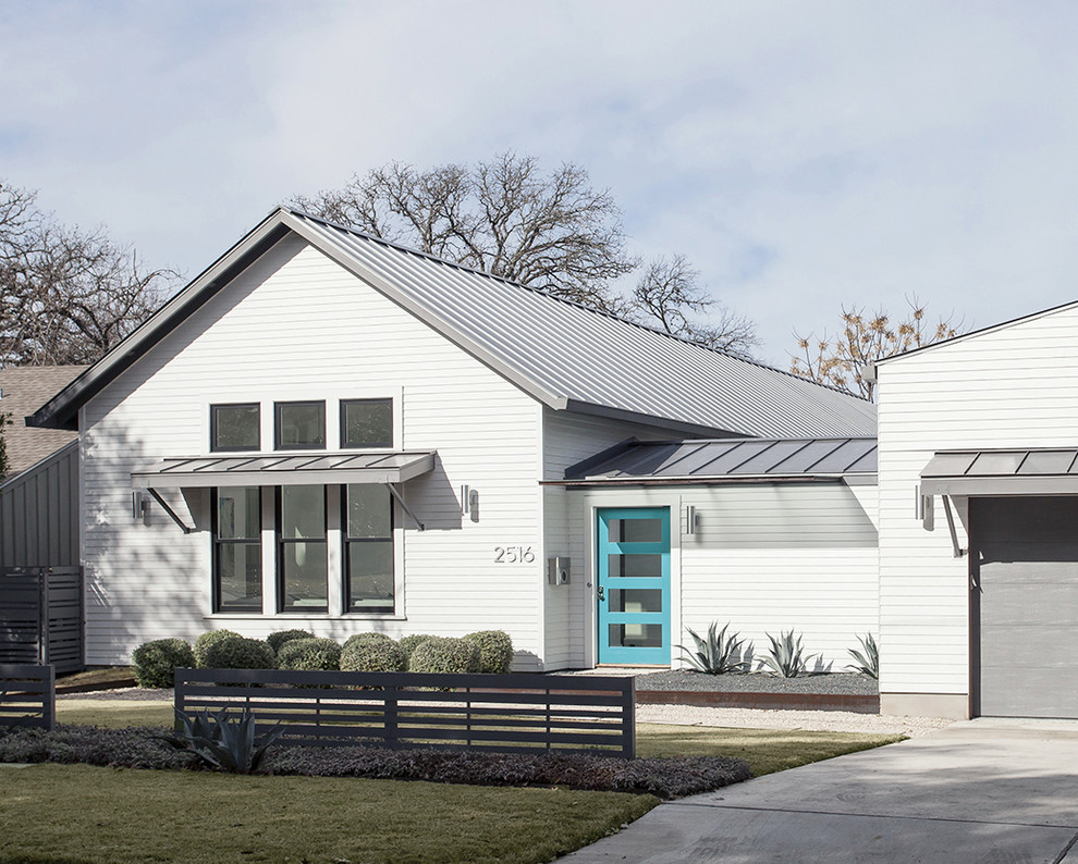 Идея дизайна: одноэтажный, белый частный загородный дом среднего размера в стиле кантри с облицовкой из винила, двускатной крышей и металлической крышей