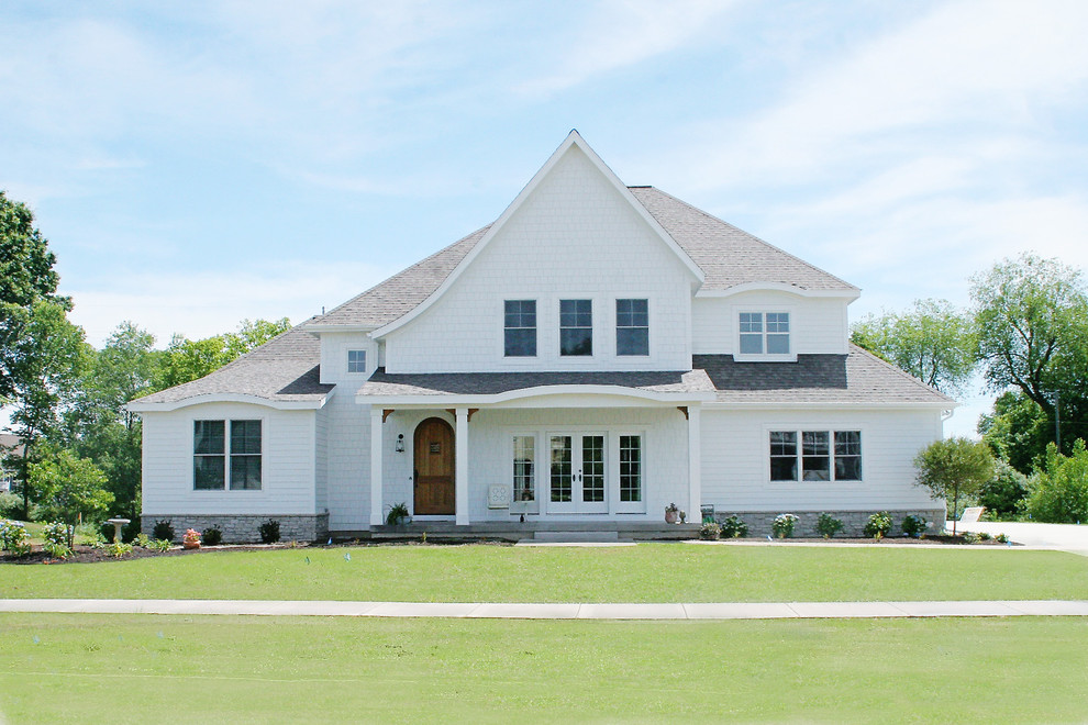 This is an example of a traditional house exterior in Grand Rapids with wood cladding.