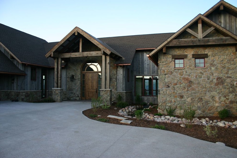 Example of a huge mountain style brown two-story wood exterior home design in Denver