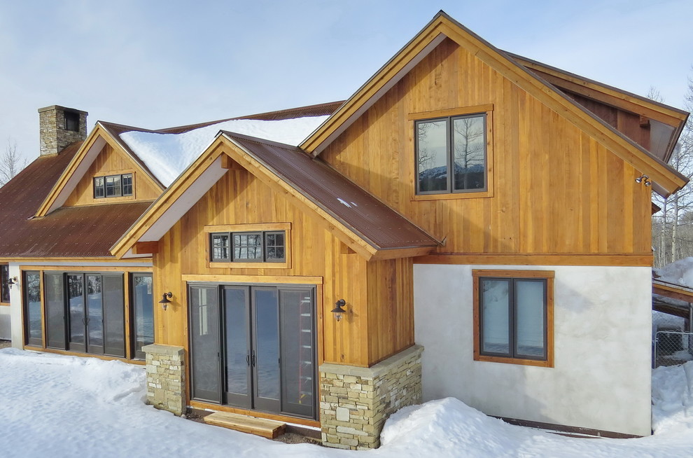 Country two floor house exterior in Other with mixed cladding.