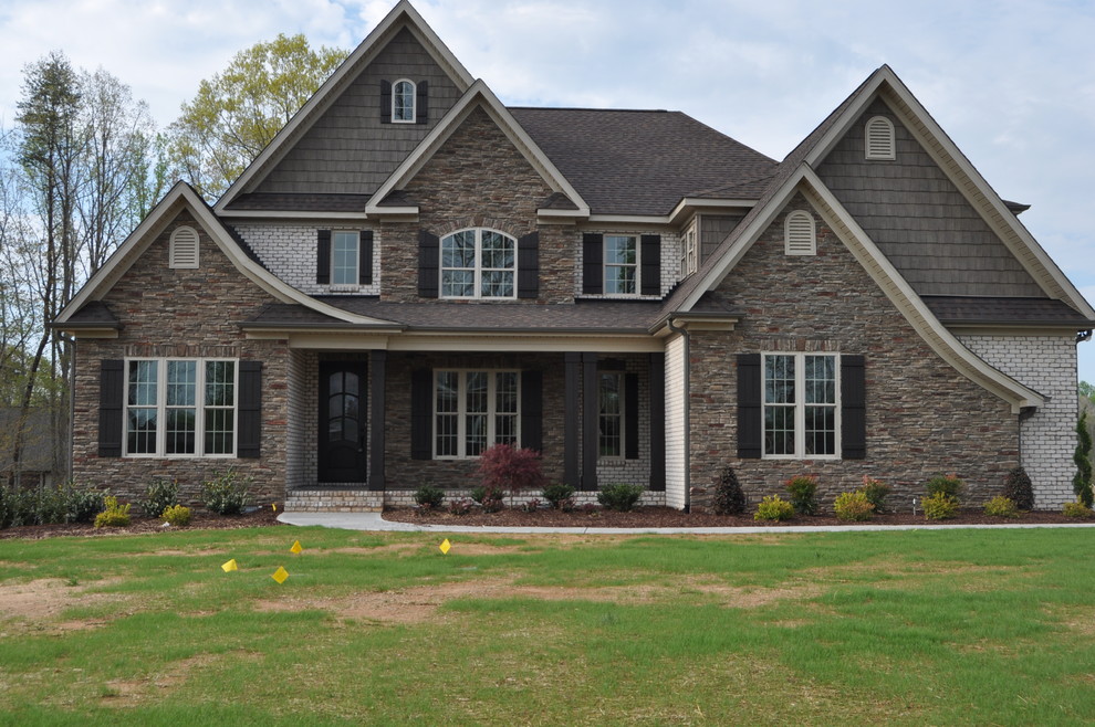 Transitional beige brick exterior home idea in Raleigh