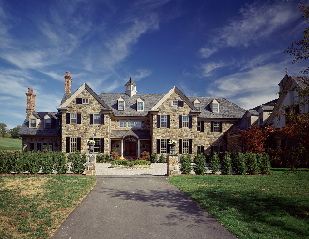 Large traditional three-story stone exterior home idea in Philadelphia with a shingle roof