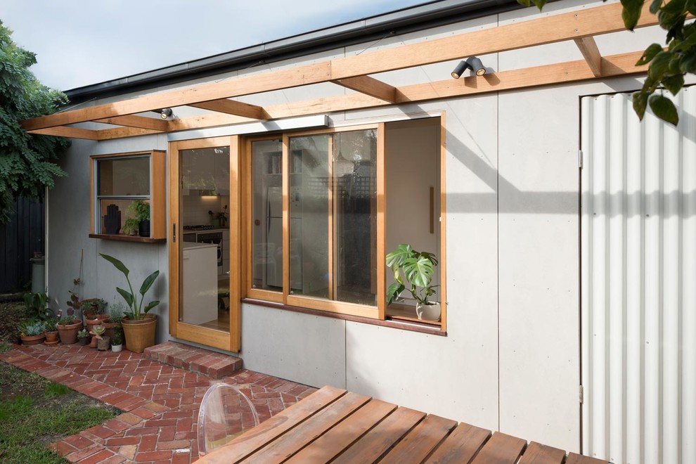 Inspiration for a small and gey scandinavian bungalow concrete detached house in Melbourne with a hip roof and a metal roof.
