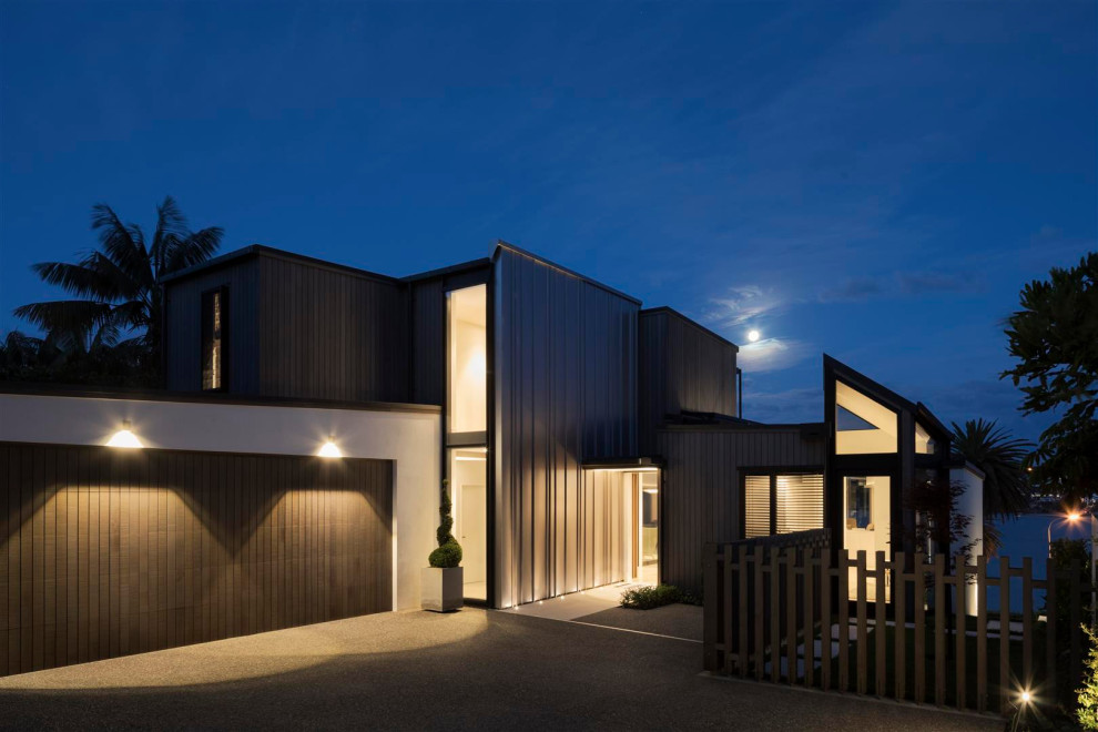 Large modern brown two-story wood house exterior idea in Auckland