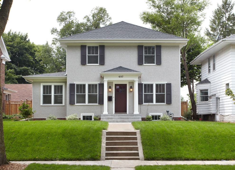 Photo of a gey traditional two floor render house exterior in Minneapolis.