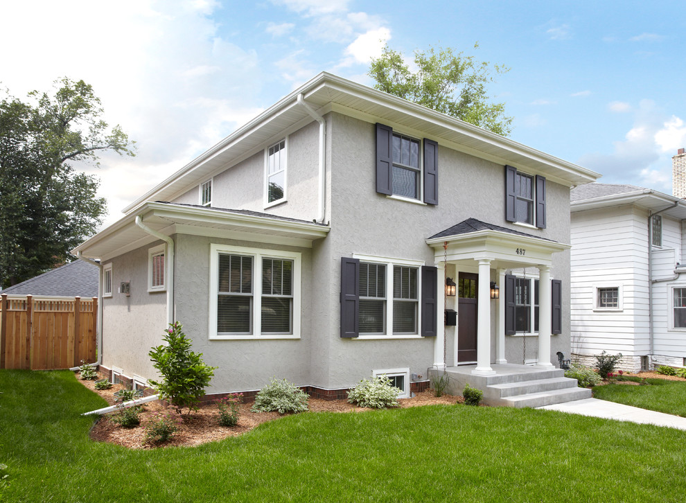 Photo of a gey traditional two floor render house exterior in Minneapolis.