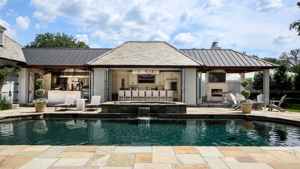 Photo of a large and white classic bungalow painted brick house exterior in New Orleans with a mixed material roof.