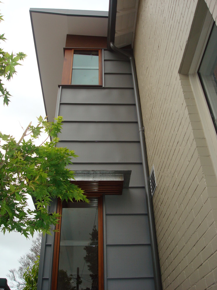 This is an example of a medium sized contemporary two floor house exterior in Sydney.