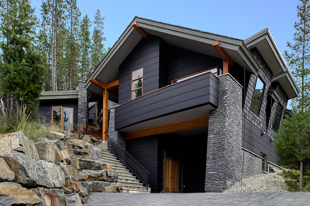 Example of a trendy black two-story exterior home design in Calgary