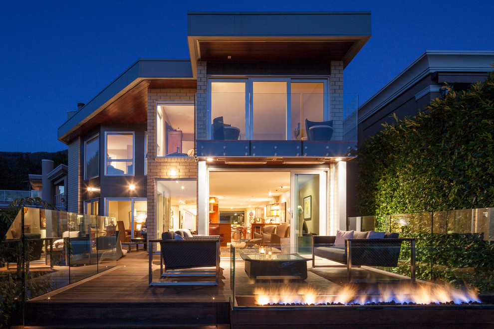 Inspiration for a contemporary beige two-story exterior home remodel in Vancouver