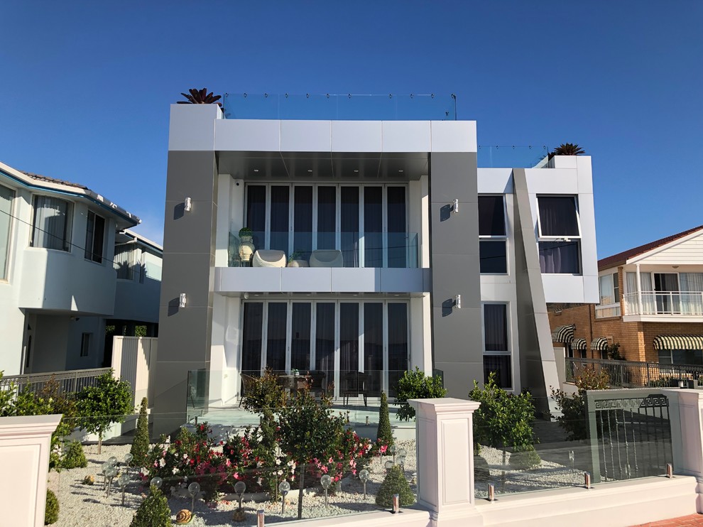 Großes, Zweistöckiges Modernes Einfamilienhaus mit Metallfassade, grauer Fassadenfarbe, Flachdach und Misch-Dachdeckung in Sydney