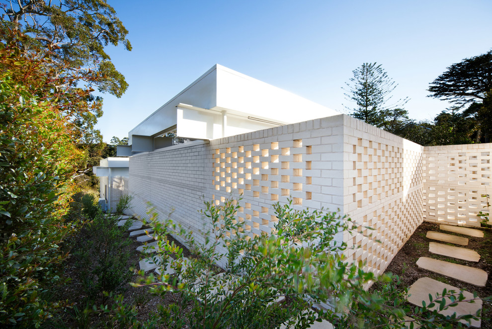 Inspiration for a modern white brick exterior home remodel in Sydney