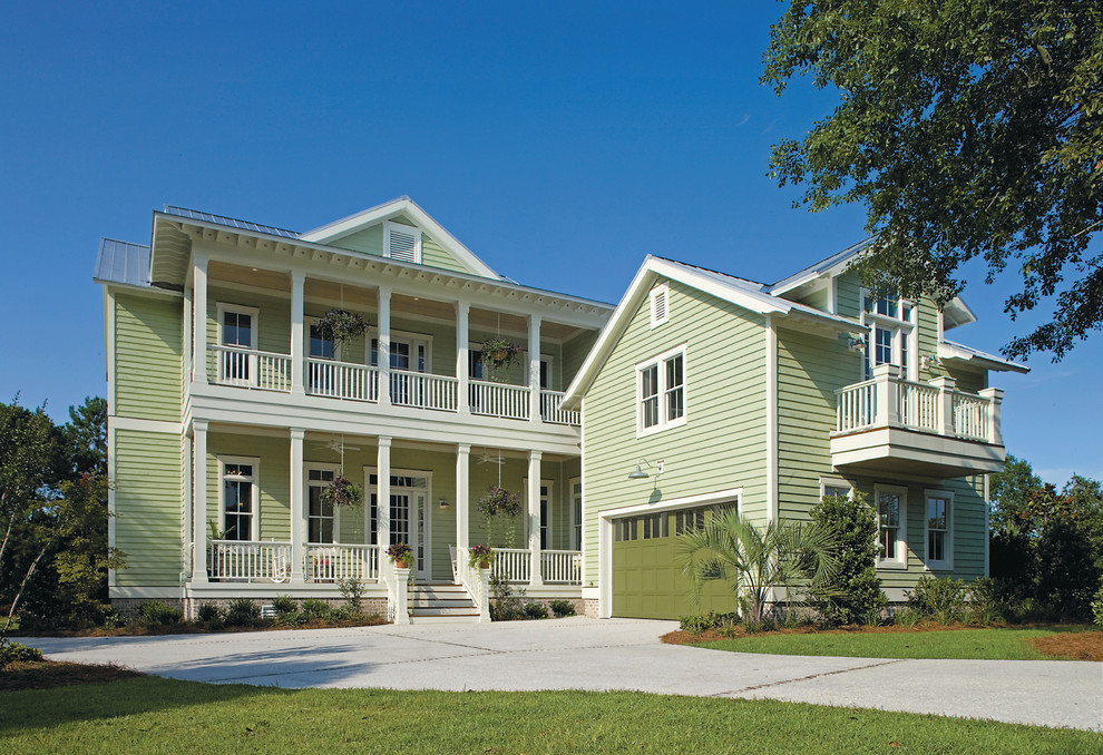 This is an example of a green nautical two floor house exterior in Wilmington with wood cladding.