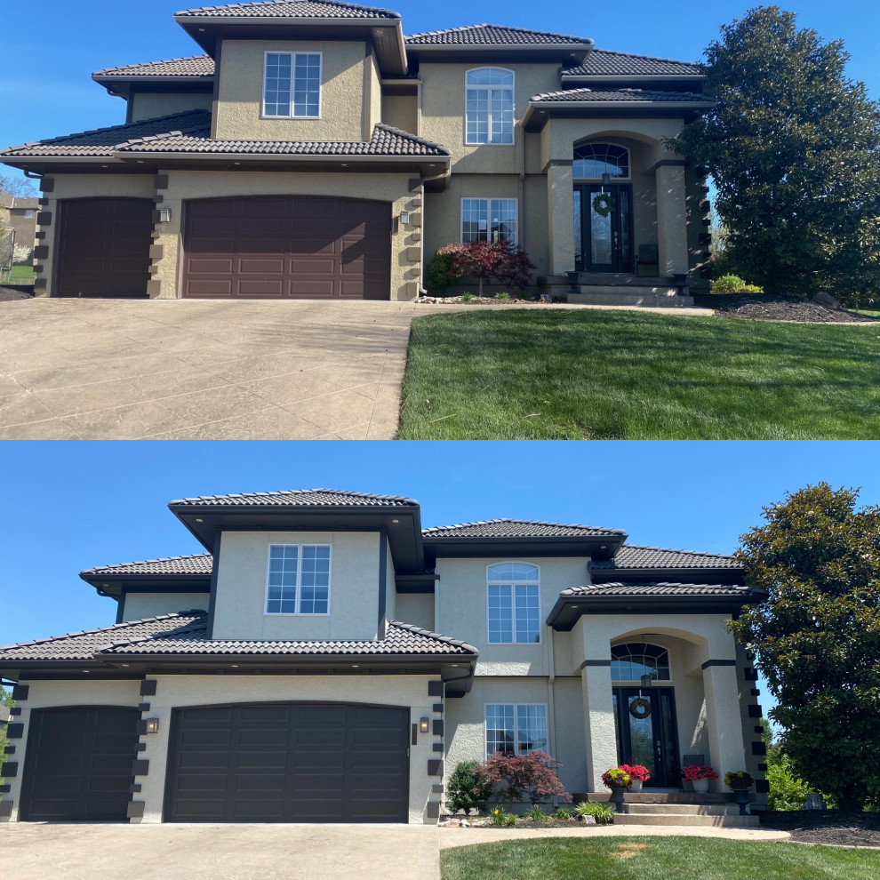 Inspiration for a contemporary beige two-story stucco house exterior remodel in Kansas City with a hip roof and a tile roof