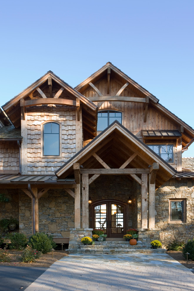 Large rustic brown three-story mixed siding exterior home idea in Other