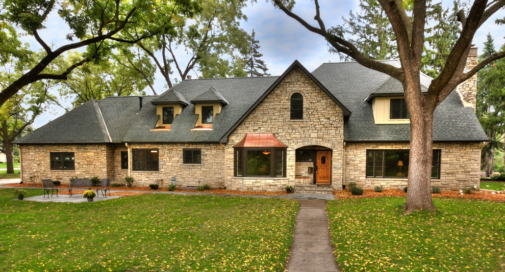 Example of a classic stone exterior home design in Minneapolis