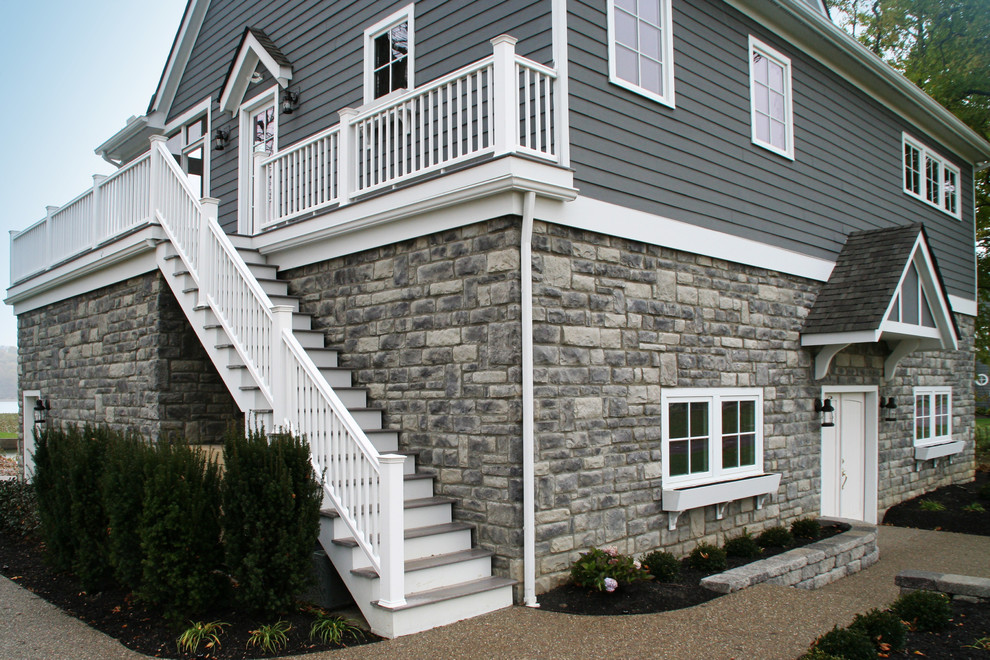 Стильный дизайн: большой, двухэтажный, серый дом в морском стиле с облицовкой из камня - последний тренд