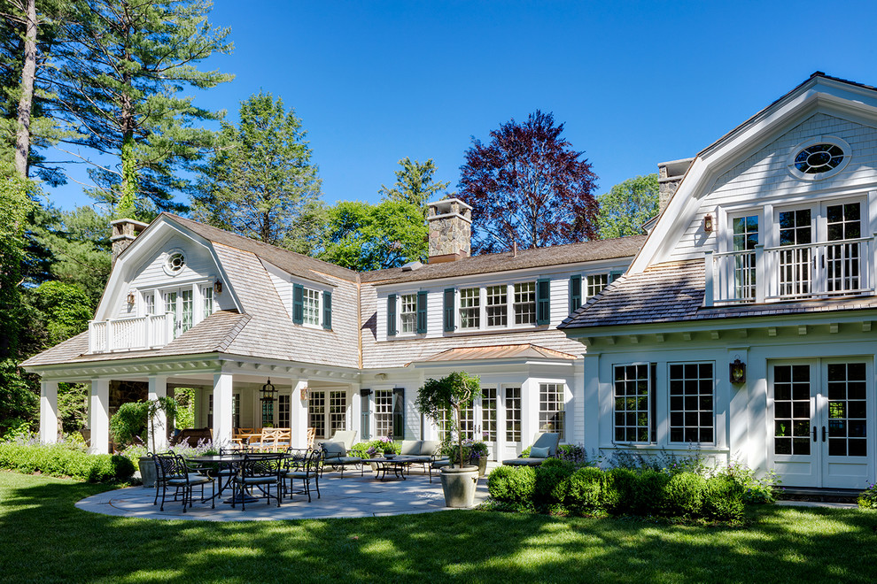 Inspiration for a large timeless white two-story wood house exterior remodel in Boston with a gambrel roof and a shingle roof