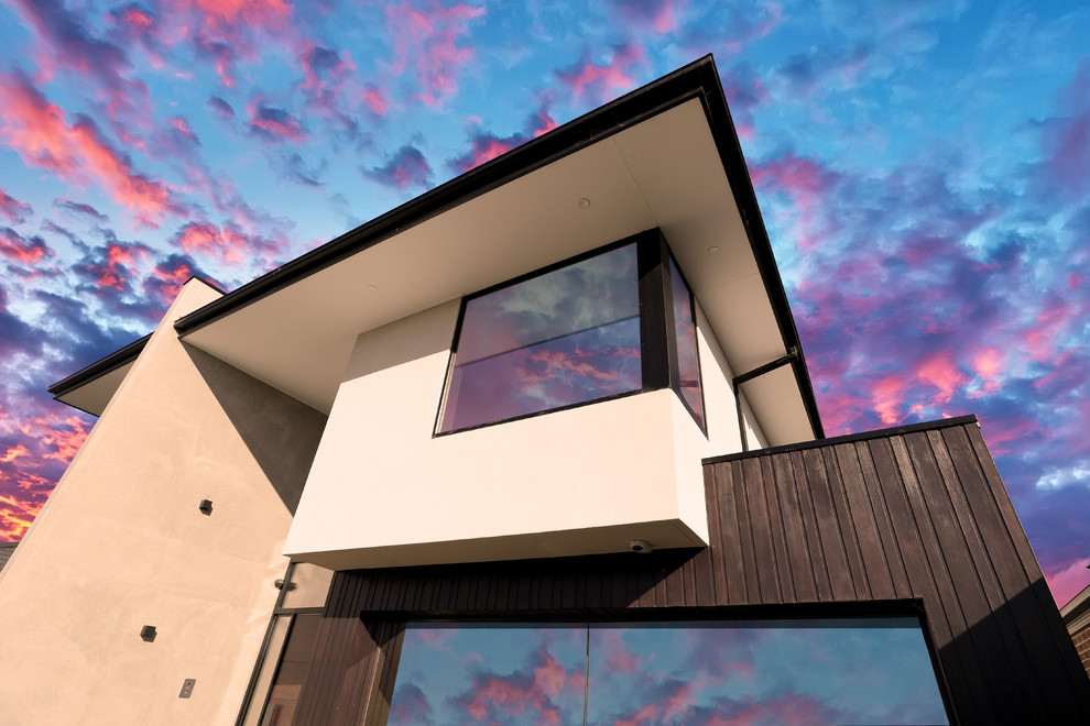 メルボルンにある高級なインダストリアルスタイルのおしゃれな家の外観 (コンクリートサイディング) の写真