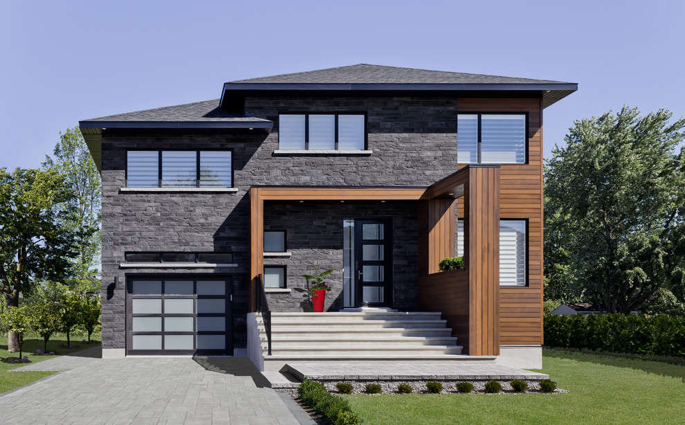 Idee per la facciata di una casa grande moderna a due piani con rivestimento in pietra