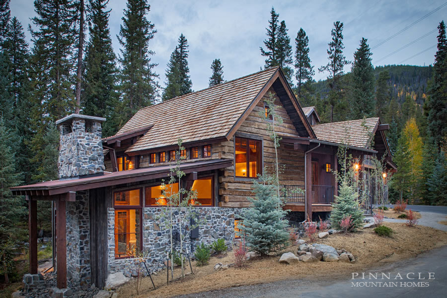 Design ideas for a medium sized and blue rustic house exterior in Denver with mixed cladding and a flat roof.