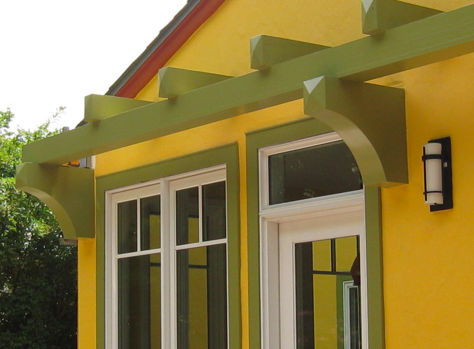 Modelo de fachada de casa amarilla mediterránea de tamaño medio de una planta con revestimiento de estuco, tejado a dos aguas y tejado de teja de madera
