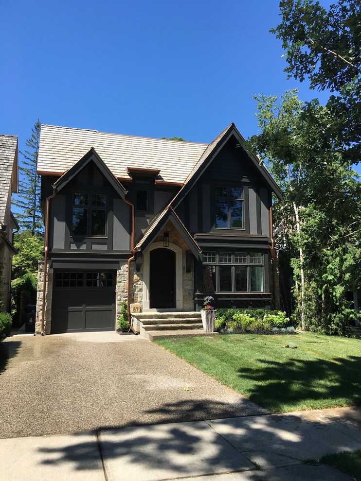 Mid-sized transitional gray two-story mixed siding exterior home idea in Toronto with a shingle roof