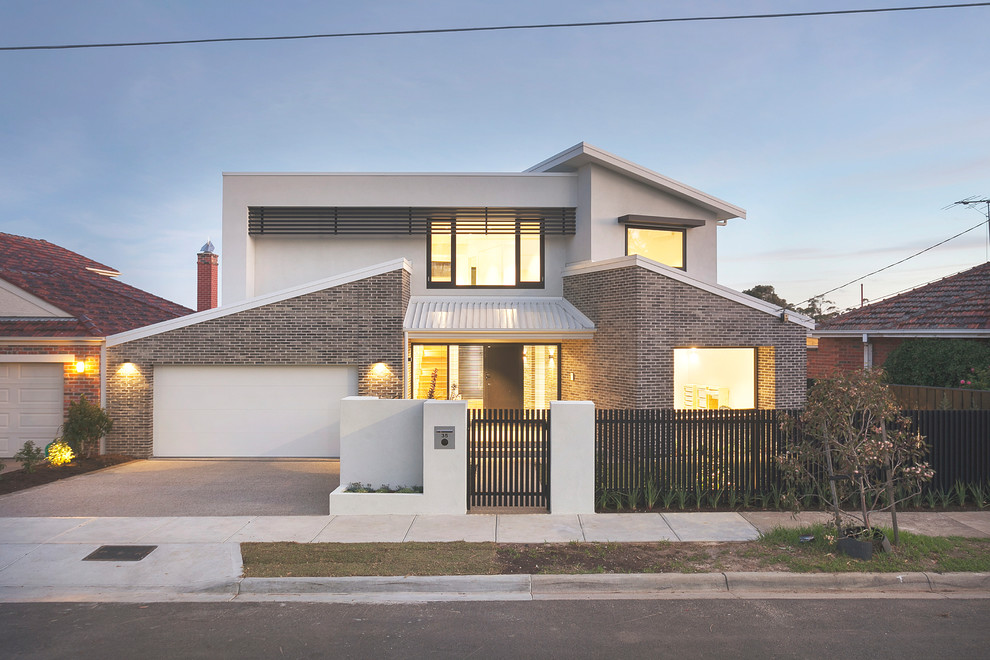 This is an example of a contemporary two floor brick detached house in Melbourne with a lean-to roof and a metal roof.