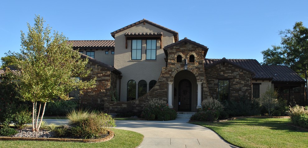 Large elegant beige two-story mixed siding exterior home photo in Dallas with a tile roof