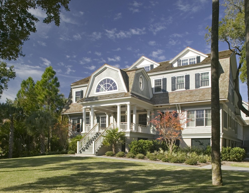 Example of a classic wood exterior home design in Charleston with a gambrel roof