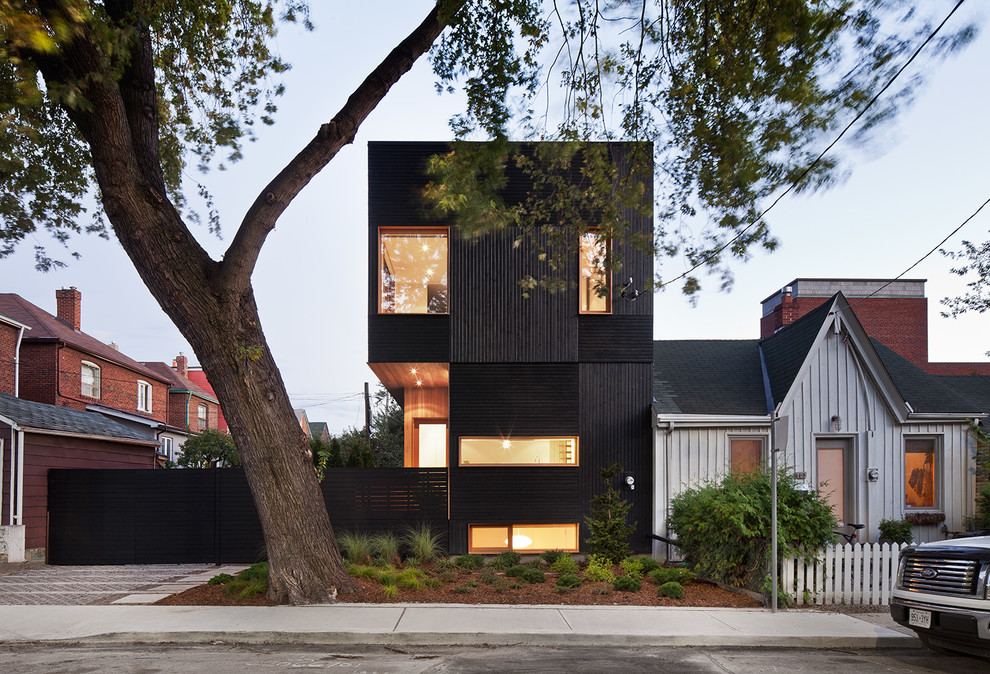 Small minimalist black two-story wood exterior home photo in Toronto