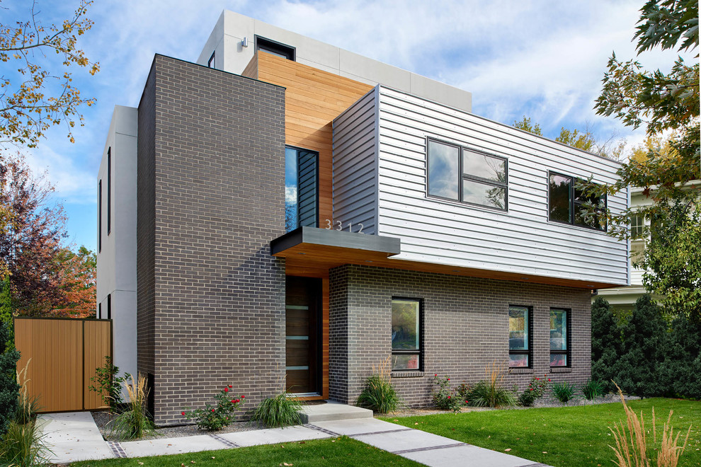 This is an example of a gey contemporary two floor detached house in Denver with mixed cladding and a flat roof.