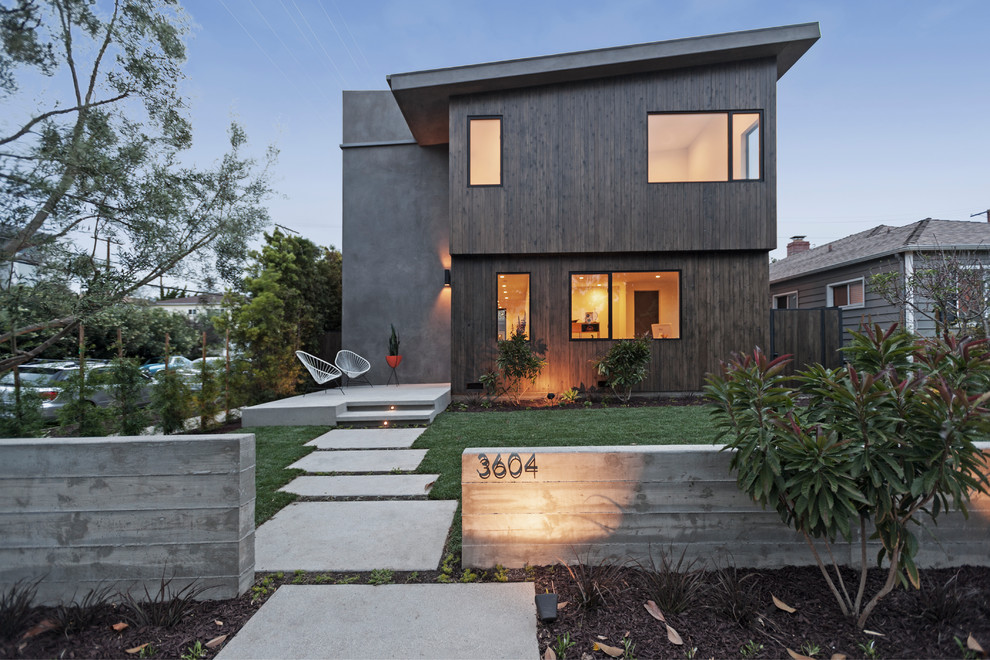Brown contemporary two floor house exterior in Los Angeles with mixed cladding and a lean-to roof.