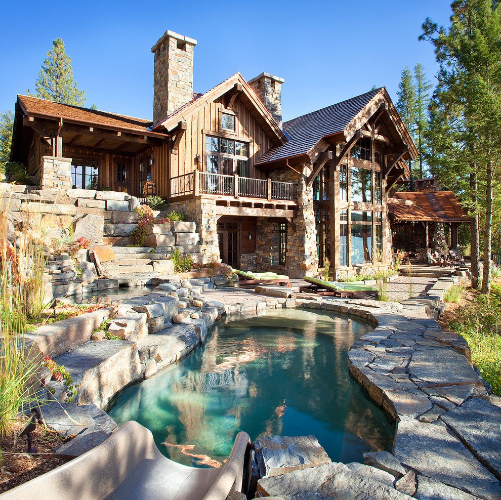 Rustic two-story wood exterior home idea in Other with a shingle roof