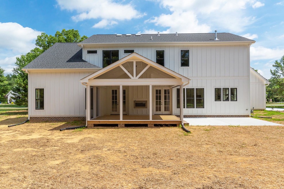 Example of a large farmhouse white two-story concrete fiberboard exterior home design in Raleigh with a mixed material roof