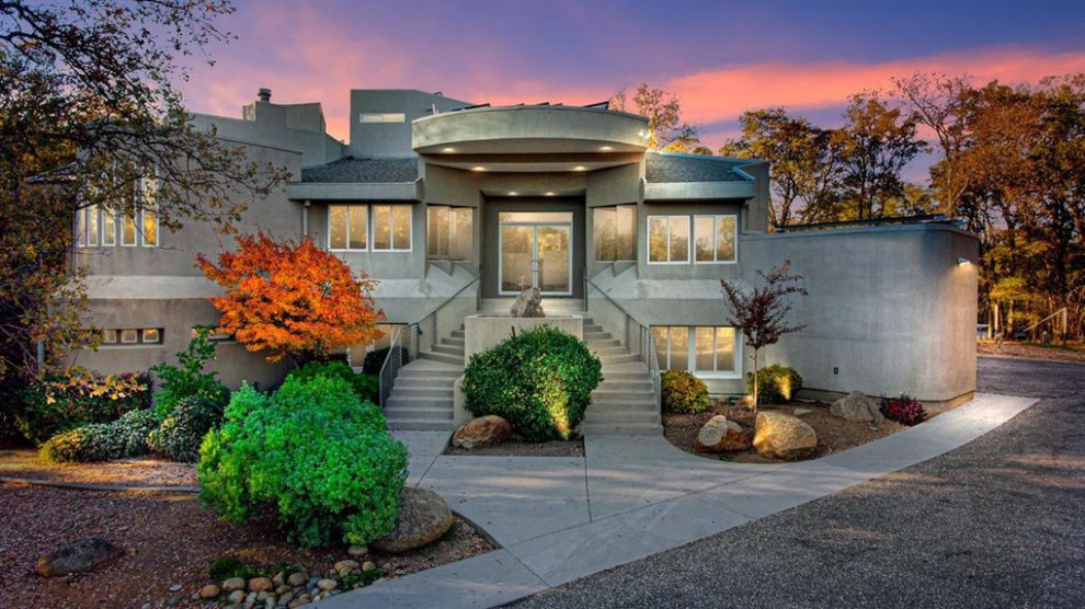 Inspiration for a large contemporary gray three-story exterior home remodel in Sacramento with a mixed material roof