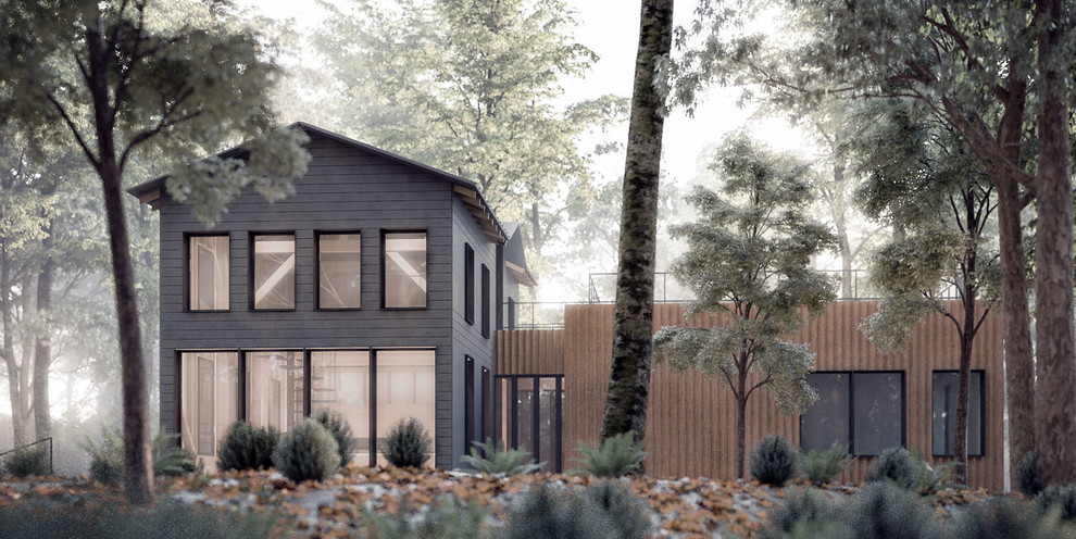 Свежая идея для дизайна: двухэтажный, черный дом среднего размера, из контейнеров, из контейнеров в стиле модернизм с облицовкой из металла и двускатной крышей - отличное фото интерьера