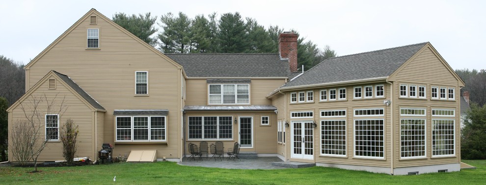 Large elegant beige two-story exterior home photo in Boston with a shingle roof