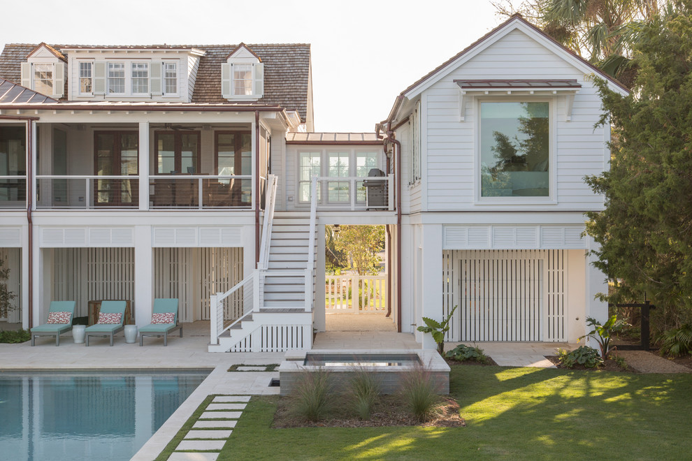 Beach style white two-story wood gable roof photo in Charleston